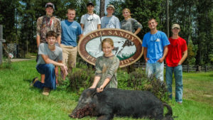 Photo of kids with hog for 30-30 Ministries website